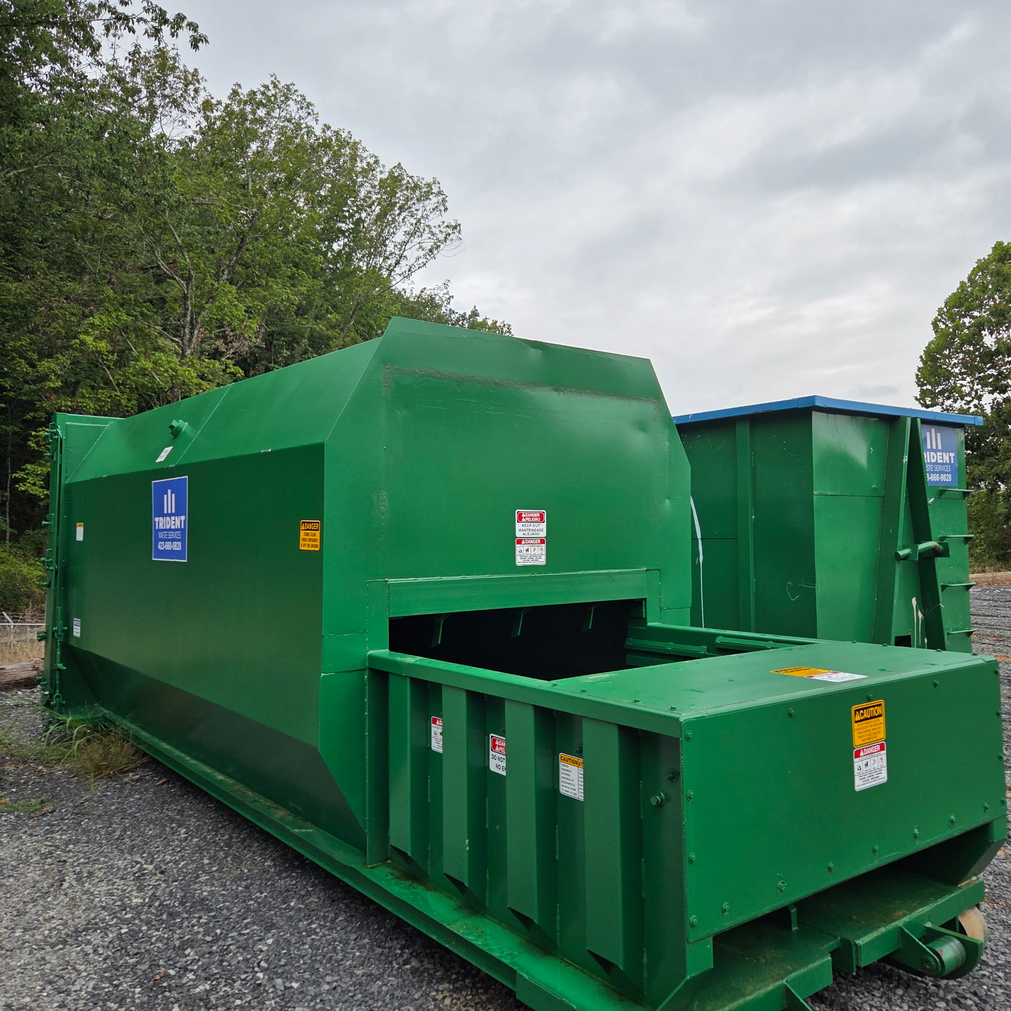 Green Trident Waste Services compactor staged at a Chattanooga commercial site