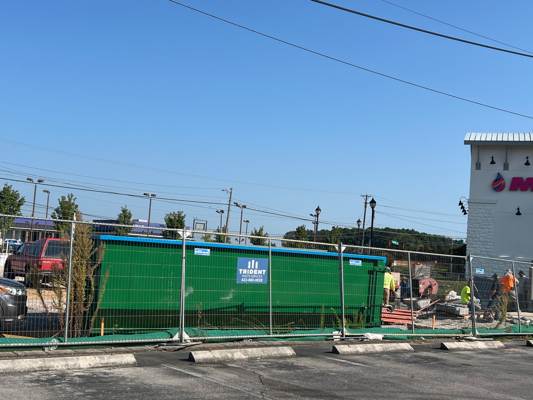 Trident Waste Services compactor on a Chattanooga commercial job site